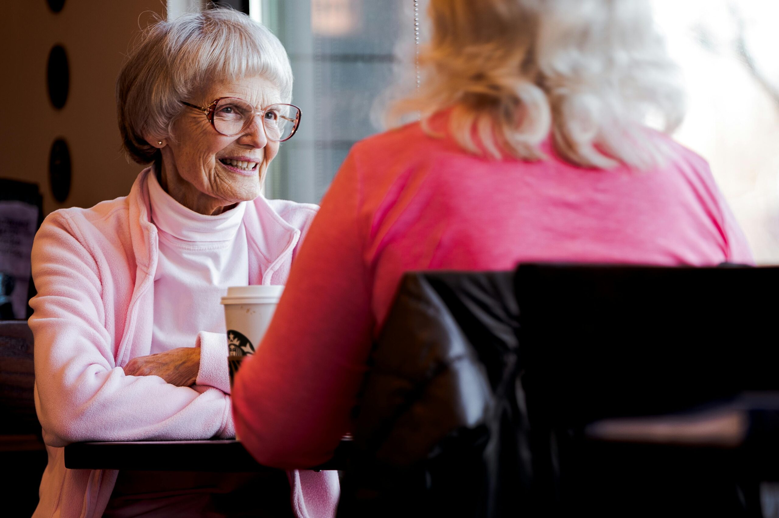 sponsorship image of two women talking over coffee